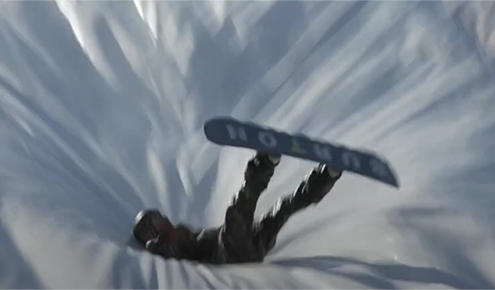 A child safely landing on a large inflatable airbag after a jump