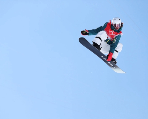 Snowboarder Valentino Guseli mid air at the 2022 Olympics