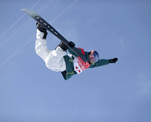 Valentino Guseli upside-down, performing a trick during the Men's Snowboard Big Air event at the Beijing 2022 Winter Olympics